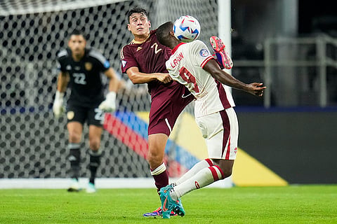 Nahuel Ferraresi and Cyle Larin compete for the ball 